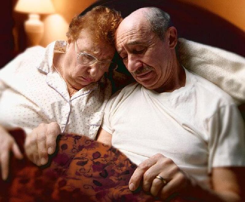 Pair of elderly people in bed