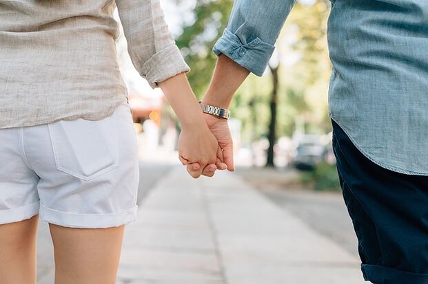 A man without potency issues holds a woman's hand
